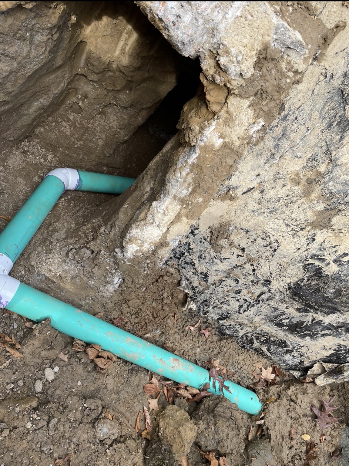 Drainage pipe routed beside a foundation